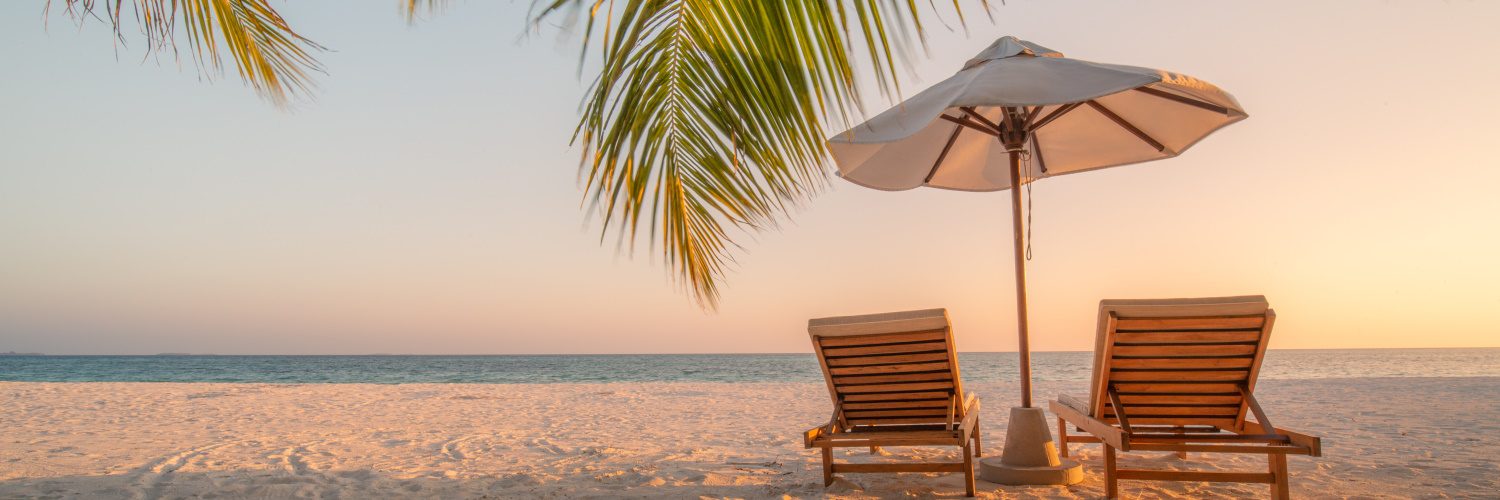 photo of two sun loungers on a beach