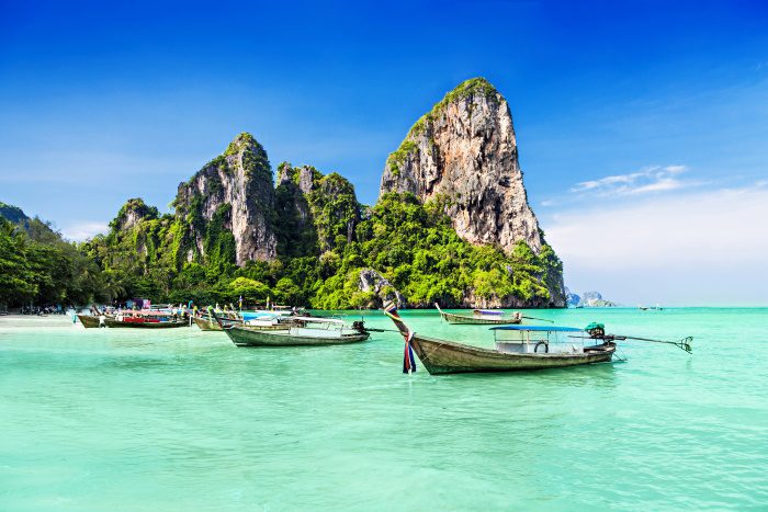 photo of clear water and boats in Krabi, Thailand