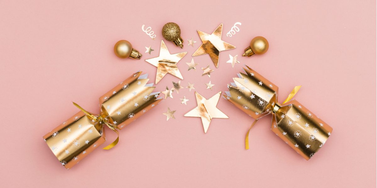 A picture of a golden cracker pulled against a salmon pink background