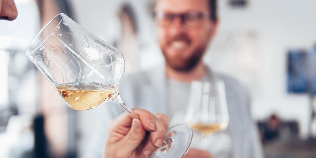 Picture of a man smelling a glass of wine